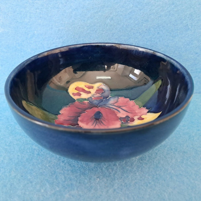 A Moorcroft Footed Bowl in the Orchid Design by Walter Moorcroft
