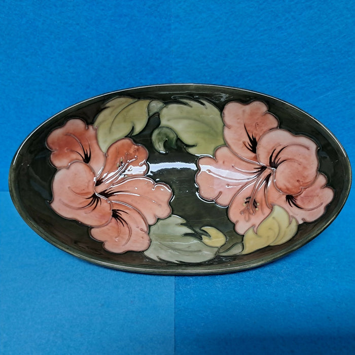 A Moorcroft Oval Bowl in the Coral Hibiscus Design by Walter Moorcroft
