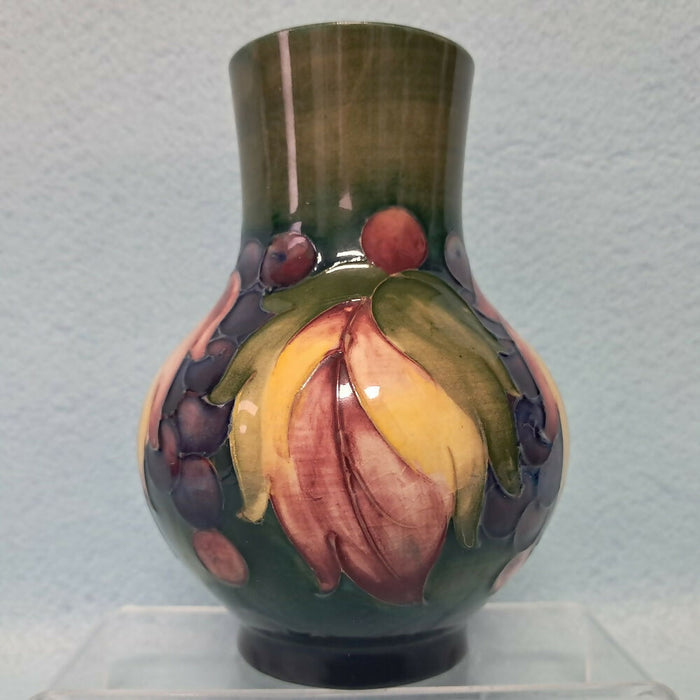 A Moorcroft Vase in the Leaf and Berry Design by William Moorcroft