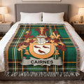 Cairnes family crest woven blanket laid across a bed.