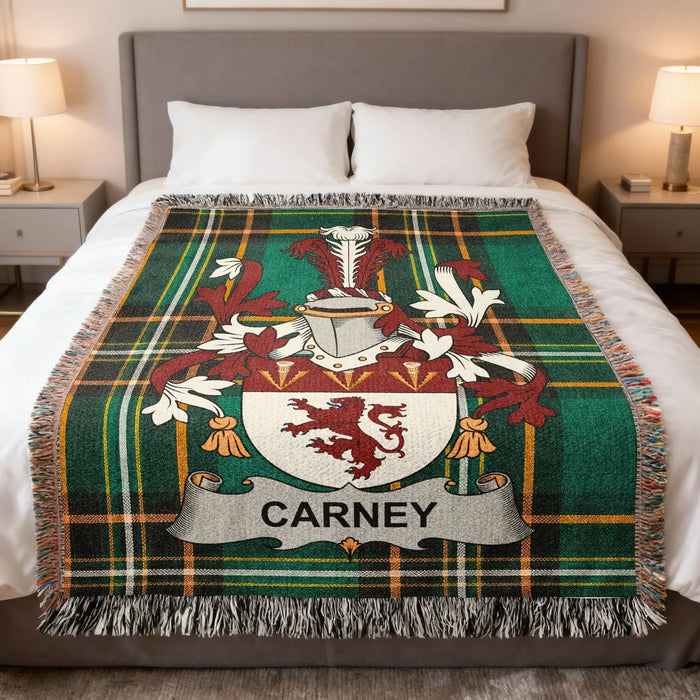 Carney family crest woven blanket laid over a bed.