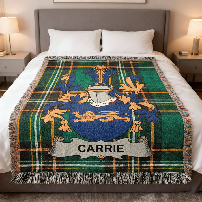 Carrie family crest woven blanket laid over a bed.