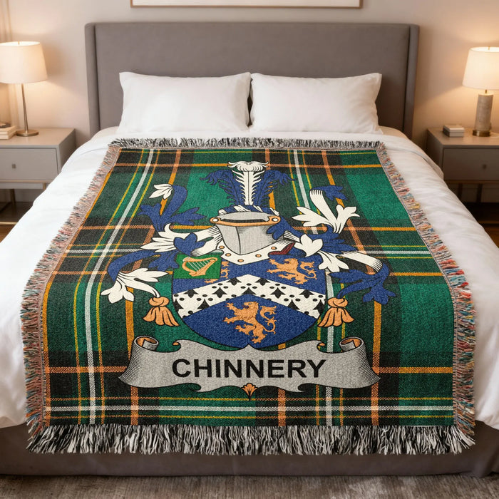 Chinnery family crest woven blanket laid across a bed.