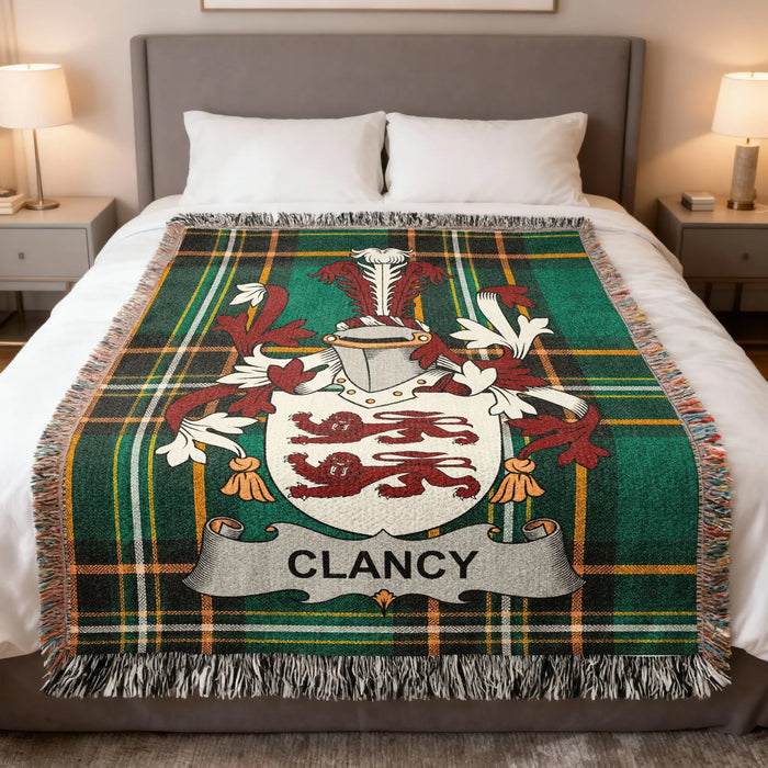 Clancy family crest woven blanket laid across a bed.