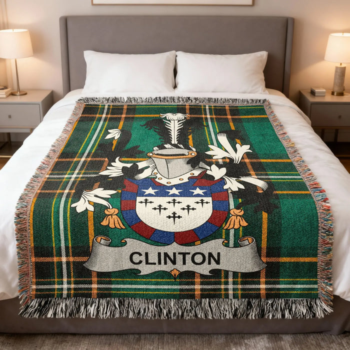 Clinton family crest woven blanket laid across a bed.