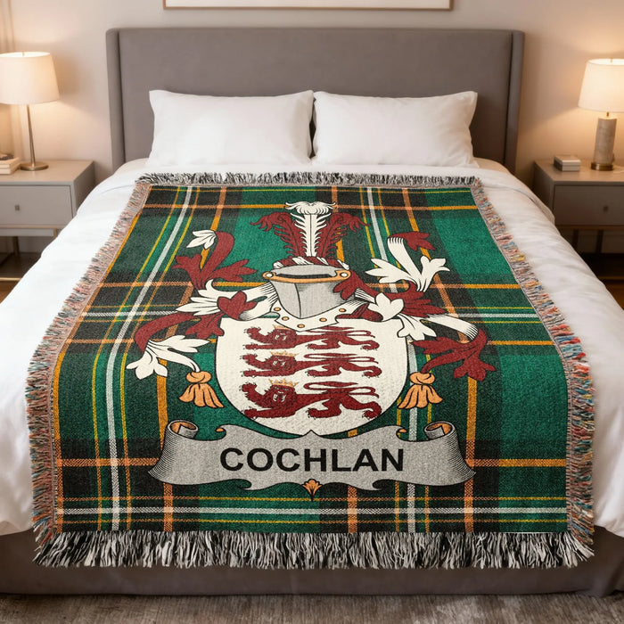 Cochlan family crest woven blanket laid over a bed.