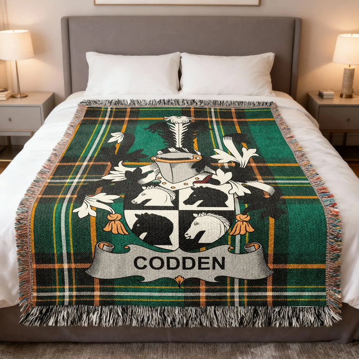 Codden Irish surname woven blanket folded at the foot of a bed on an Irish National Tartan background