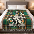 Codden Irish surname woven blanket folded at the foot of a bed on an Irish National Tartan background