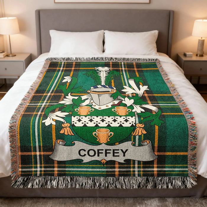 Coffey family crest woven blanket laid across a bed.