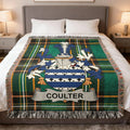 Coulter family crest woven blanket laid over a bed.