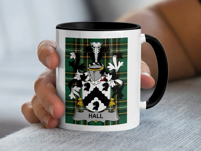Mug with a Hall family crest on a green plaid background.